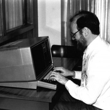 [Harvey Brenneise working on a computer in the James White Library]