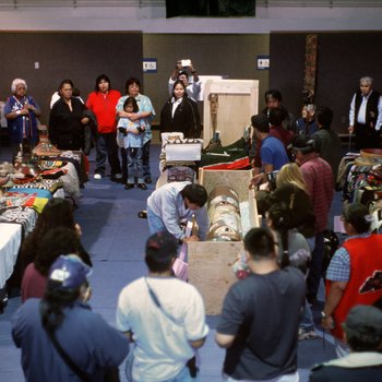 Members of the Tlingit Nation unpack a recently returned Bear Clan Totem during a welcoming ceremony in Angoon, Alaska, November 1, 2003