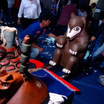 Members of the Tlingit Nation position the top of a a recently returned Bear Clan Totem during a welcoming ceremony in Angoon, Alaska, November 1, 2003