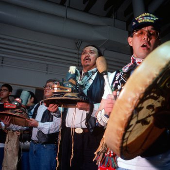 Members of the Tlingit Nation sing for a recently returned Bear Clan Totem during a welcoming ceremony in Angoon, Alaska, November 1, 2003