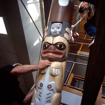 University of Northern Colorado facilities workers carefully lower a Tlingit Bear Clan Totem from its mount in the University Center, October 20, 2003 3