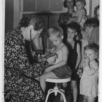 Dr. Elva Wright Examining Children, c. 1940