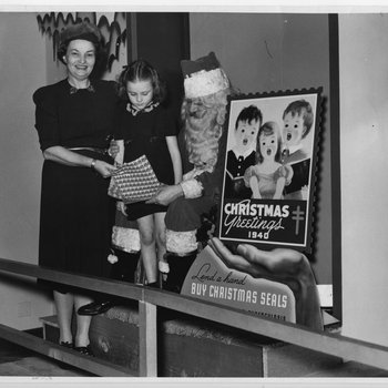 Little Miss Christmas Seal presents seals to Santa Claus, 1940