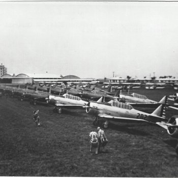 Melvin L Pape AT-6 Harvards on the Parking Line with BT-13A in background