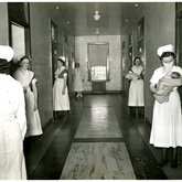 Nurses and nursing students in a hall at Memorial Hospital, 1935