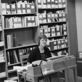 Library Staff at Desk (1976)