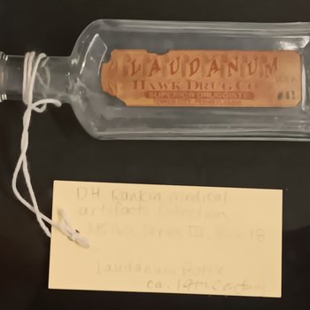 Small glass bottle with cork and label “Laudanum”