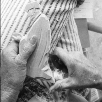 Polly Page carving a doll (close-up)