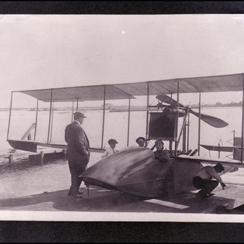 Tony Jannus Poses with Passenger on the Benoist Airboat No. 43 While a Young Boy and Two Others Stand Nearby, Tampa