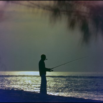 Man fishing from shoreline, Freeport, Grand Bahama Island, Bahamas