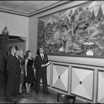 Group Looks at Painting at the Columbia Restaurant