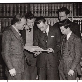Group of law students reading book