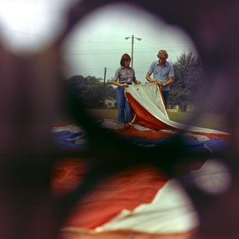 Man and Woman Inspecting a Balloon