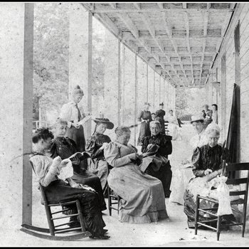 Mrs. John Armfield sewing with unidentified ladies seated at the Beersheba Inn gallery.