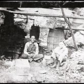 Two men posing in front of a moonshine still, Claiborne County, Tennessee, 1903