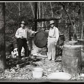 Homer Copeland and Joe Colagross at a still belonging to W. L. Hogue, Maury or Lewis County, Tennessee, ca. 1940