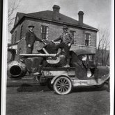 Sheriff Henry Barker and Deputy Jim Taylor Stewart with a confiscated still in front of the Sequatchie County Jail, Dunlap, Tennessee, ca. 1920