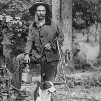 Daniel Duesst (pronounced "due east") with his gun, his dog, and his jug of moonshine Sequatchie County, Tennessee, ca. 1900