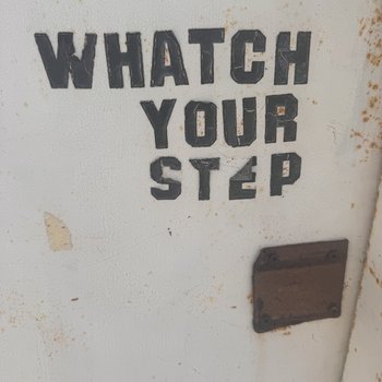 Photograph of "Whatch Your Step" Sign