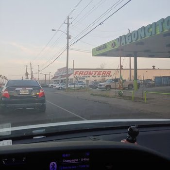 Photograph of El Vagoncito Restaurant Sign y Frontera Collision Auto Parts