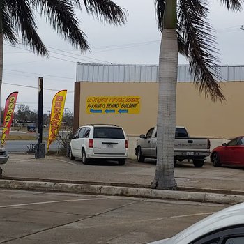 Photograph of "Pupusas To Go! Llenas De Sabor" Sign