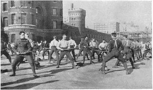 1914 - The Fighting Lawyer; black and white photograph of men in combat training poitions.
