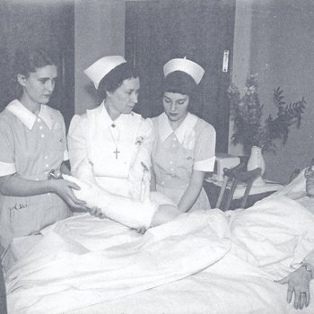 Nurses assisting patient