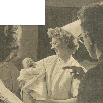 Nurse holding crying infant
