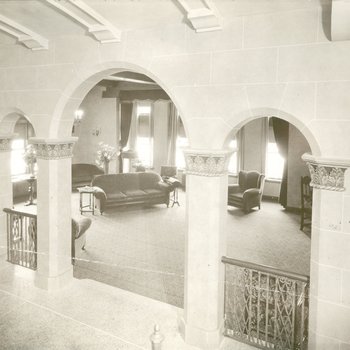Sitting room of nurses' dormitory through stone archway, 1931
