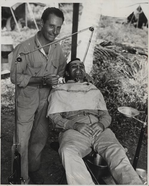 Lieutenant Louis N. Heller provides dental treatment at his military post on Guadalcanal Official US Marine Corps Photo