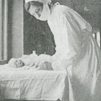 Masked nurse with infant