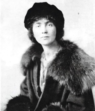 Interwar-era black and white photograph of Edith Featherston wearing velvet tam hat wool coat with large fur collar and cuffs.