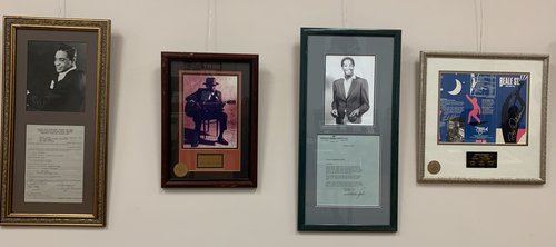 4 framed items hang on the wall: Standard AFTRA Engagement Contract for Jackie Wilson; Framed autographed photo of John Lee Hooker; Letter from Sam Cooke, using William Morris Agency letterhead, to the American Broadcasting Company. 9 December 1963; Brochure for the Beale St. Memphis Festival signed by Roy Orbison, Jerry Lee Lewis, Mark James, Carl Perkins, Stevie Ray Vaughn