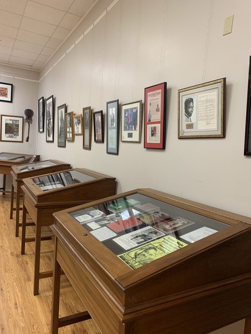 view of exhibit space, including framed items among display cases.