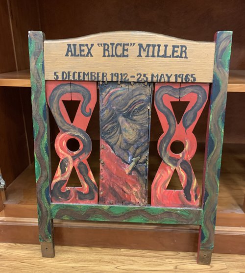 a painted chairback in tribute to Alex "Rice" Miller.