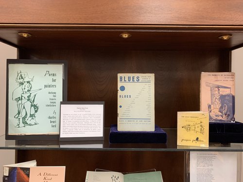 display of publications by Charles Henri Ford: Poems for Painters, Blues A Magazine of New Rhythms, The Half Thoughts, The Garden of Disorder. exhibit card about Ford in photo has been transcribed on the page.
