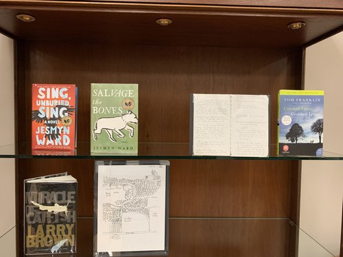 display case containing publications by Jesmyn Ward and Tom Franklin