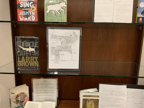 display case containing A Miracle of Catfish by Larry Brown with a hand drawn map.