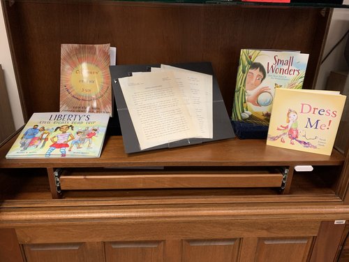 display case containing publications by Michael Walters, Kabir and Arjun Gupta, Thelma T. Collums, Matthew Clark Smith, and Sarah Frances Hardy