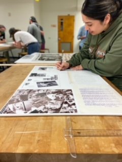 Student Kathy Aguirre arranging images on foamcore to get the correct dimentions before cutting.