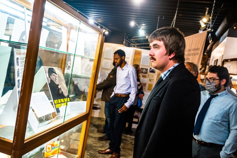 History graduate students Brian Fombuh, Andrew Fitzgerald, and Micah Lambert check out the Letters To/From Home display