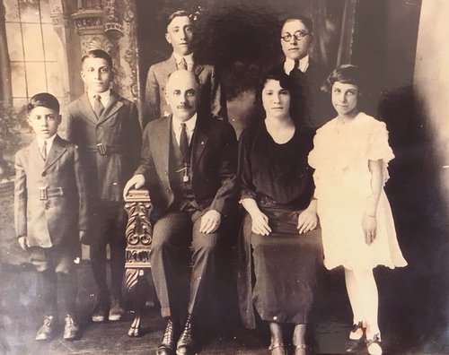 Thomas family portrait (left to right): Leon, William, Ernest, S.N. (seated), Saleemi, Edward, and Victoria