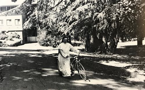 "Sister Nicholas with Bicycle." Humanitas: Dominican College Of San Rafael Yearbook, 1976, p. 106.