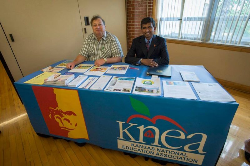 Jayawardhana and Bob Kehle at a KNEA table with flyers