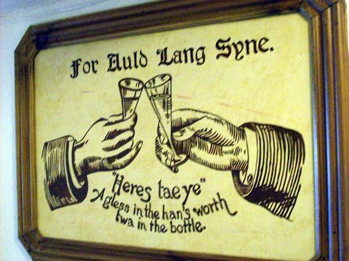 tavern plaque reading "For Auld Lang Syne, heres tae ye. A gless in the han&#x27;s worth twa in the bottle."