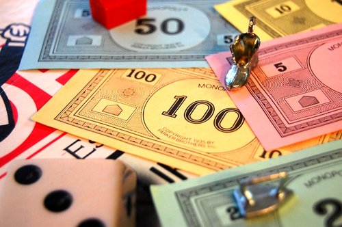 playing pieces, dice, and paper money from the board game Monopoly