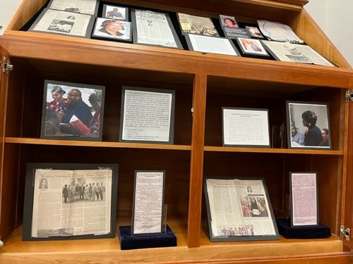 display case containing newspaper columns of Dottie Quaye Chapman Reed, and associated photographs