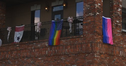 A variation of the classic rainbow flag hangs from a Tupelo balcony