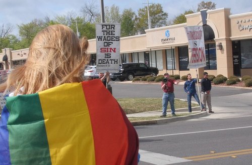 Protestors along the Starkville Pride parade route