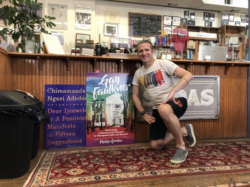Philip Gordon poses with a poster for his monograph, Gay Faulkner